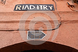 Traditional Riad in Morocco with the sign on the wall.