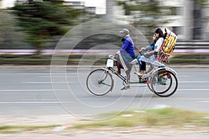 Traditional Rickshaw Transporting Passengers in Urban Setting