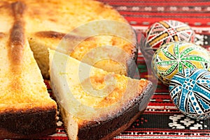 Traditional romanian easter bread pasca with cheese and raisins and nicely decorated easter eggs orthodox tradition
