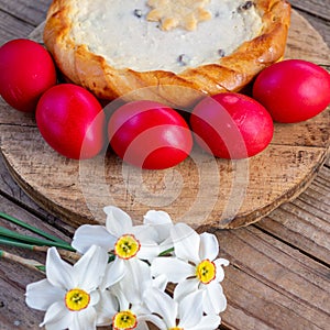 Traditional romanian easter dish cozonac and pasca or sweetbread and cheese pie like on wooden table and colored easter eggs