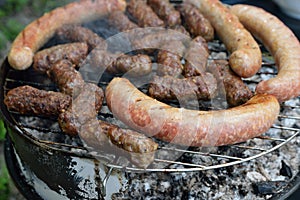 Traditional Romanian food, barbecue with grilled meat rolls, mititei or mici (beef, pork and lamb meat) and sausages