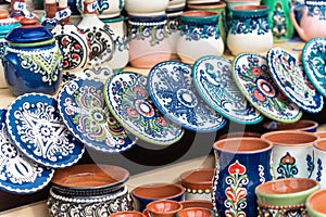 Traditional romanian handmade ceramic pottery plates with rustic authentic decoration paintings on display