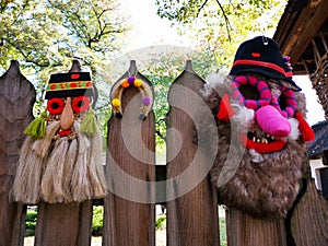 Traditional romanian masks on wooden fence