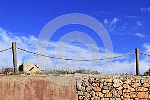 Traditional rope fence over stone wall grunge