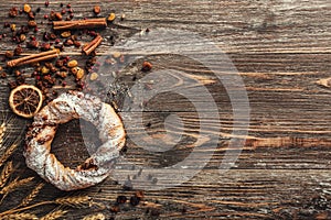 Traditional round cracknel, dried fruits and wheat on rustic wooden background. Top view, light effect photo