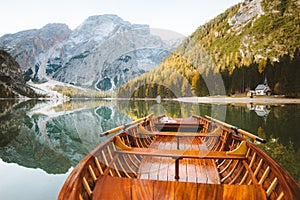 Traditional rowing boat on alpine lake in fall