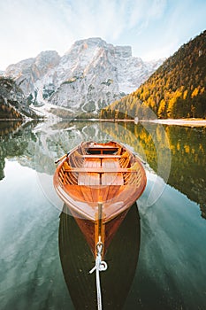 Traditional rowing boat at Lago di Braies at sunrise in fall, South Tyrol, Italy