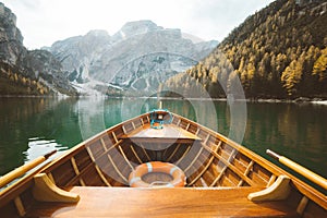 Traditional rowing boat on a lake in the Alps in fall