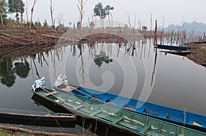 Traditional rural view of wooden fishing boats in small village near river in Laos