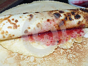 Traditional russian blini with lingonberry jam. Pancakes. Pancake week. Maslenitsa is an Eastern Slavic traditional holiday