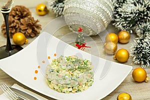 Traditional Russian christmas salad Olivier with sausage and fresh cucumbers
