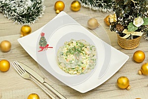 Traditional Russian christmas salad Olivier with sausage and fresh cucumbers