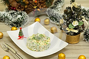 Traditional Russian christmas salad Olivier with sausage and fresh cucumbers