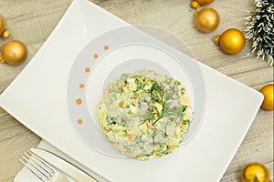 Traditional Russian christmas salad Olivier with sausage and fresh cucumbers