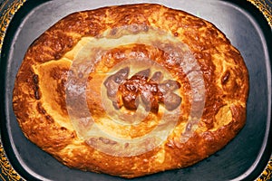 Traditional Russian closed pie with cabbage - kulebyaka, top view