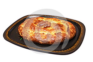 Traditional russian closed pie with cabbage on a tray, isolated on white background