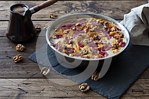 Traditional Russian dessert Guriev Porridge, Semolina porridge with dried fruits and walnuts, honey, cinnamon, cream, raspberry