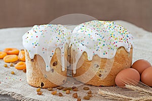 Traditional russian easter cake also called kulich with sugar icind, dried apricots and raisins on vintage textile