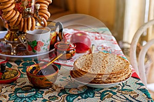 Traditional Russian food,pancakes with caviar, stand on the table with a samovar