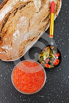 Traditional russian food. Red caviar and fresh baked bread.