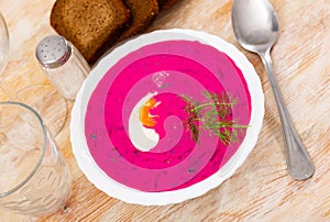 Traditional Russian Holodnik, cold yogurt beetroot soup with cucumber decorated by egg and dill