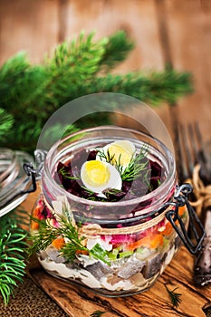 Traditional Russian layered betroot and herring salad under a f photo