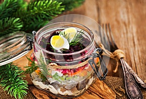 Traditional Russian layered betroot and herring salad under a f photo