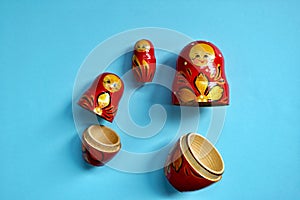 Traditional Russian matryoshka dolls isolated on a blue background