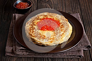Traditional russian pancakes blini with red caviar