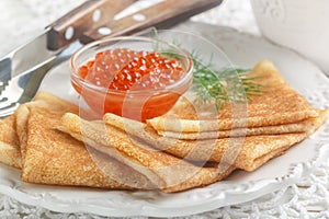 Traditional Russian pancakes blini with salmon caviar photo