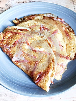 traditional Russian pancakes with ham on a plate