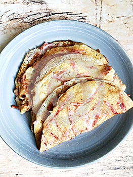 traditional Russian pancakes with ham on a plate