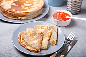 Traditional Russian pancakes with red caviar.