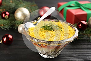 Traditional russian salad Mimosa and festive decor on dark table