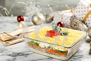 Traditional russian salad Mimosa and festive decor on white marble table