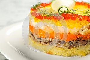 Traditional russian salad Mimosa on plate, closeup