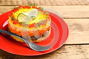 Traditional russian salad Mimosa served on wooden table, closeup