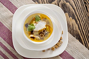 Traditional Russian soup solyanka saltwort closeup in a bowl on the table.