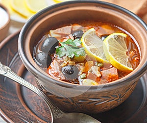 Traditional Russian soup Solyanka with meat, sausages, vegetables