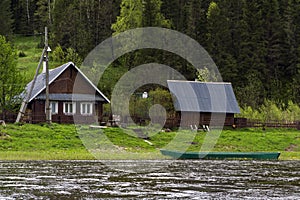 Traditional russian village house on the river bank