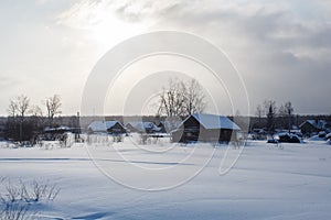 Traditional russian village in wintertime during sunset
