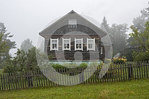 Traditional Russian wooden house (izba) in the countryside.