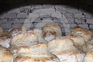 traditional rustic bread cooking on stone charcoal oven