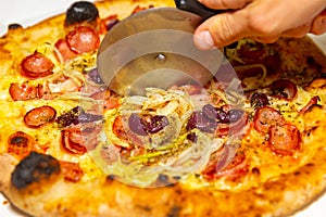 Traditional rustic pizza with pepperoni, black olives, onion and basil