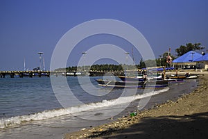 Traditional sailing wooden boat on the water parking at the harbour in summer holiday in Lampung, Indonesia