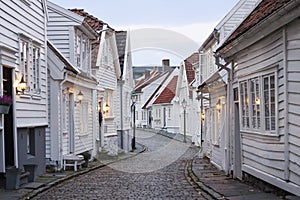 Traditional scandinavian cobblestone street with white houses in Stavanger, Norway