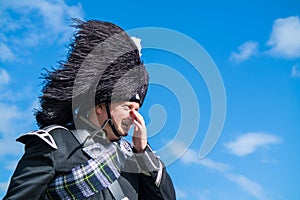 Traditional scottish bagpiper in full dress