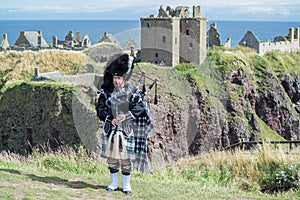 Traditional scottish bagpiper in full dress code