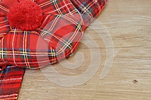 Traditional Scottish Red Tartan Bonnet and Scarf on Wood Board