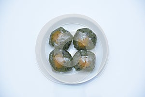 A plate of Qingtuan stuffed with egg yolk and dried meat floss isolated on white background. photo